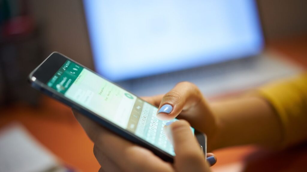 mulher enviando mensagem de cobrança por whatsapp